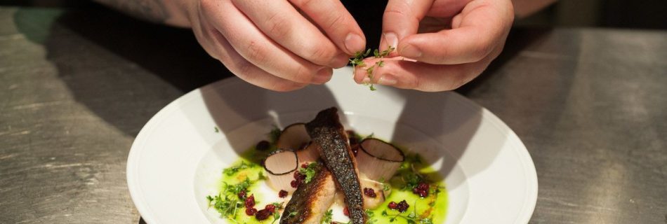 Chef preparing food at Häktet Restaurant in Stockholm